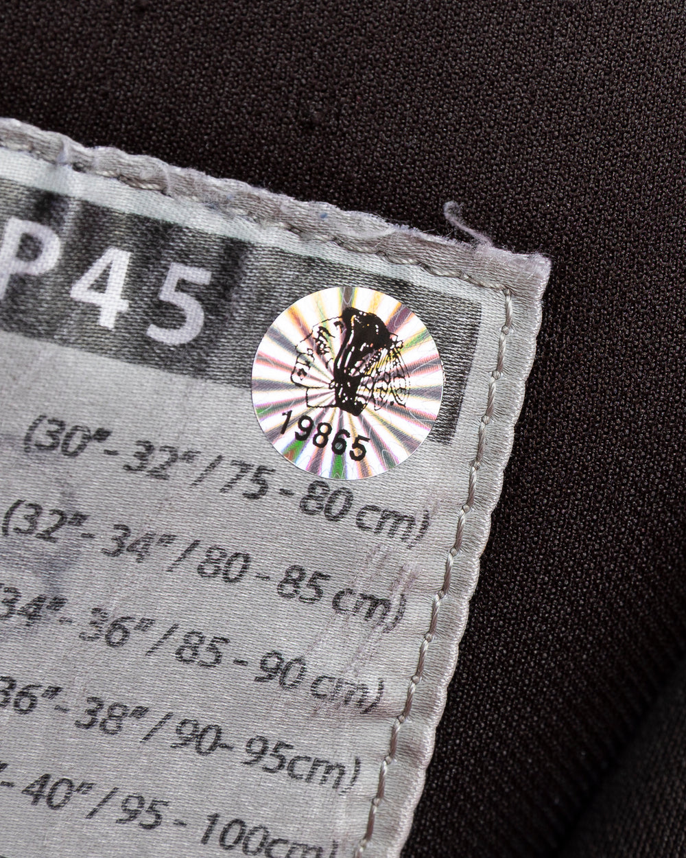 black CCM hockey pants used by Chicago Blackhawks player Ryan Donato - hologram sticker detail lay flat