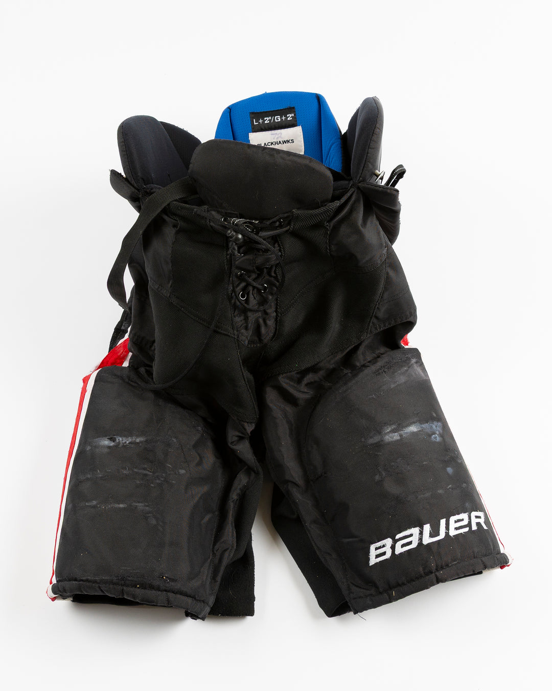 black Bauer hockey pants used by Chicago Blackhawks player Alex Vlasic - front lay flat