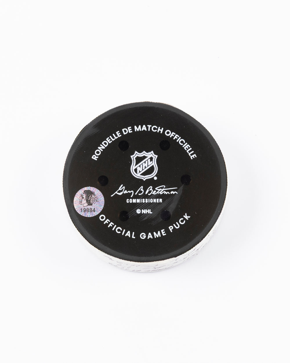 official hockey goal puck scored by Chicago Blackhawks player Joe Veleno on 3/28/25 - back lay flat