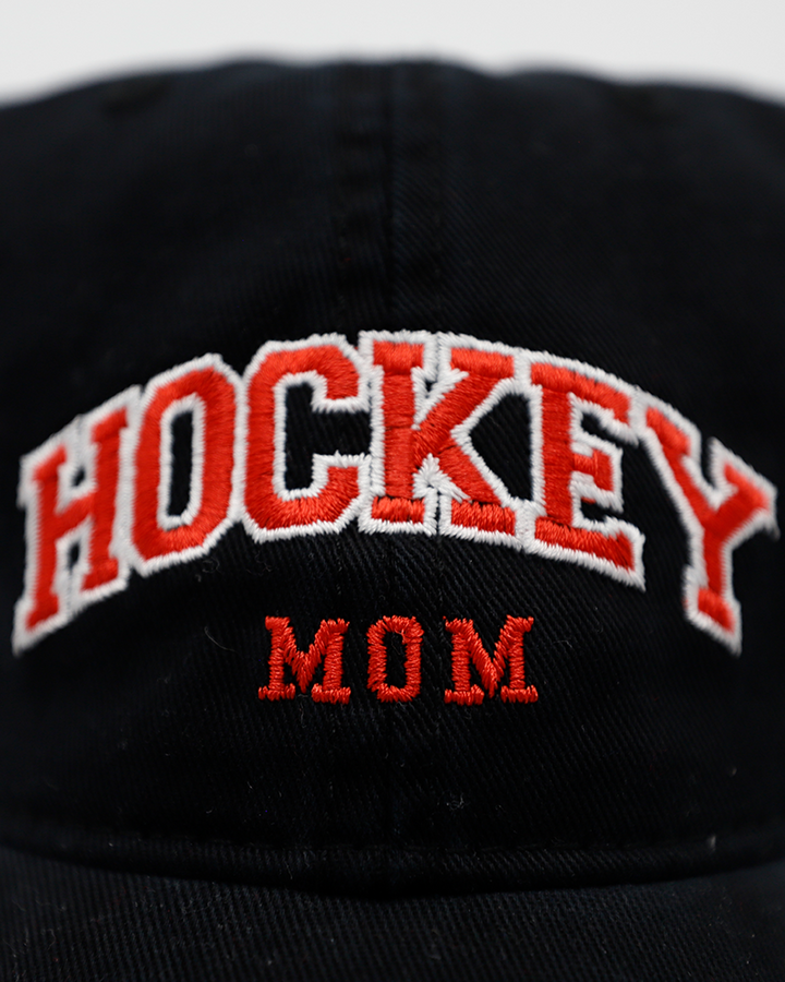 black Legacy adjustable hat with embroidered red Hockey Mom wordmark on front and Rockford IceHogs Hammy logo on left side - front detail lay flat