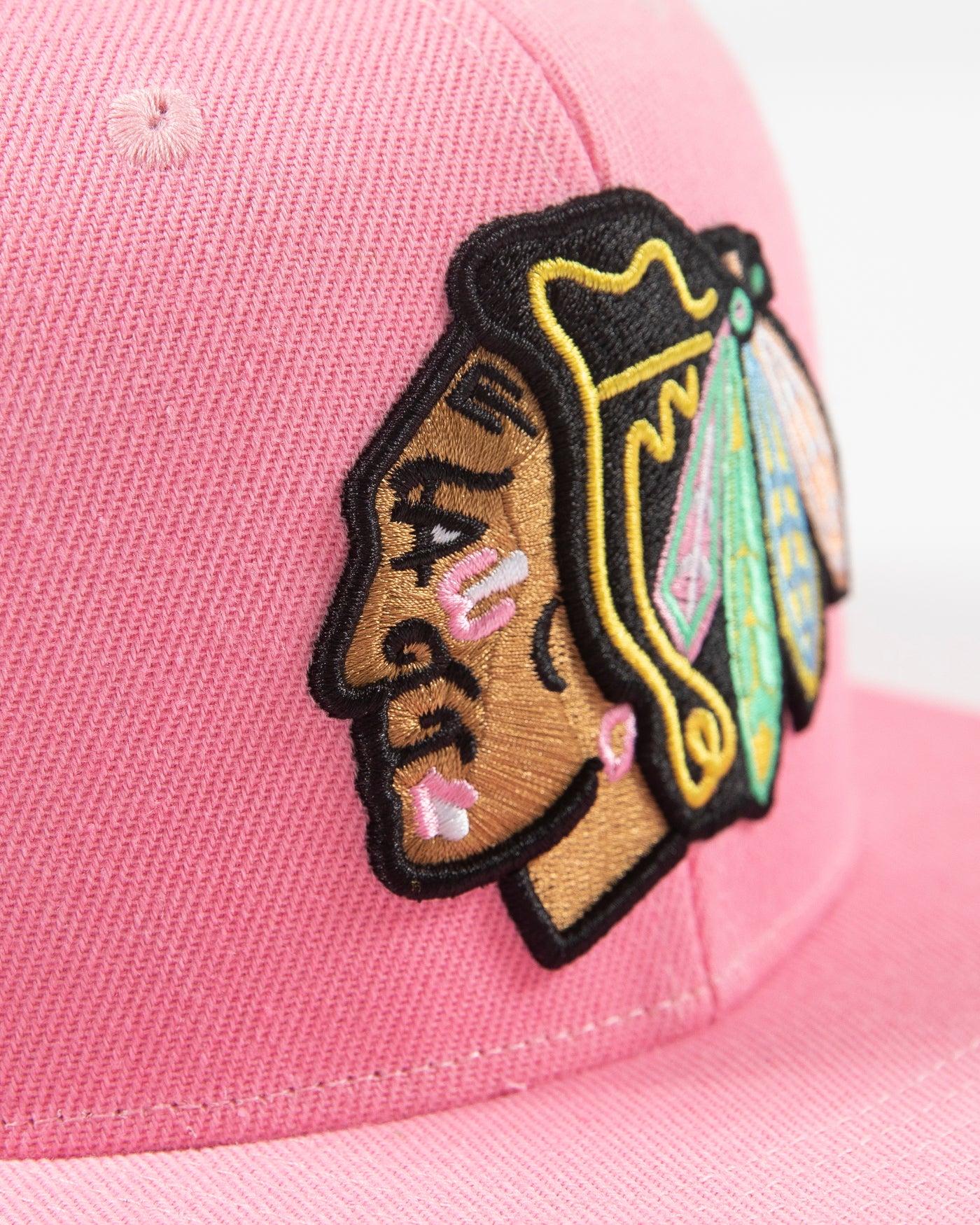 Mitchell & Ness pink snapback with Chicago Blackhawks primary logo embroidered on the front with pink accents - detail lay flat