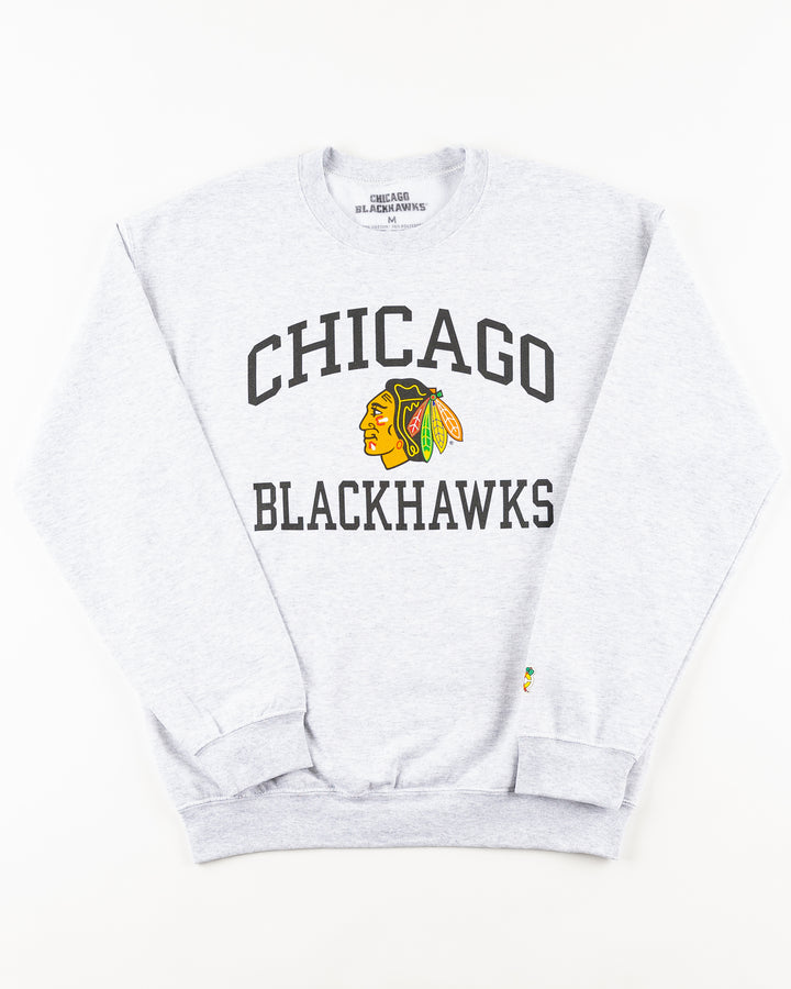grey Chicago Blackhawks crewneck with wordmark and primary logo on chest and secondary logo on left wrist - front lay flat