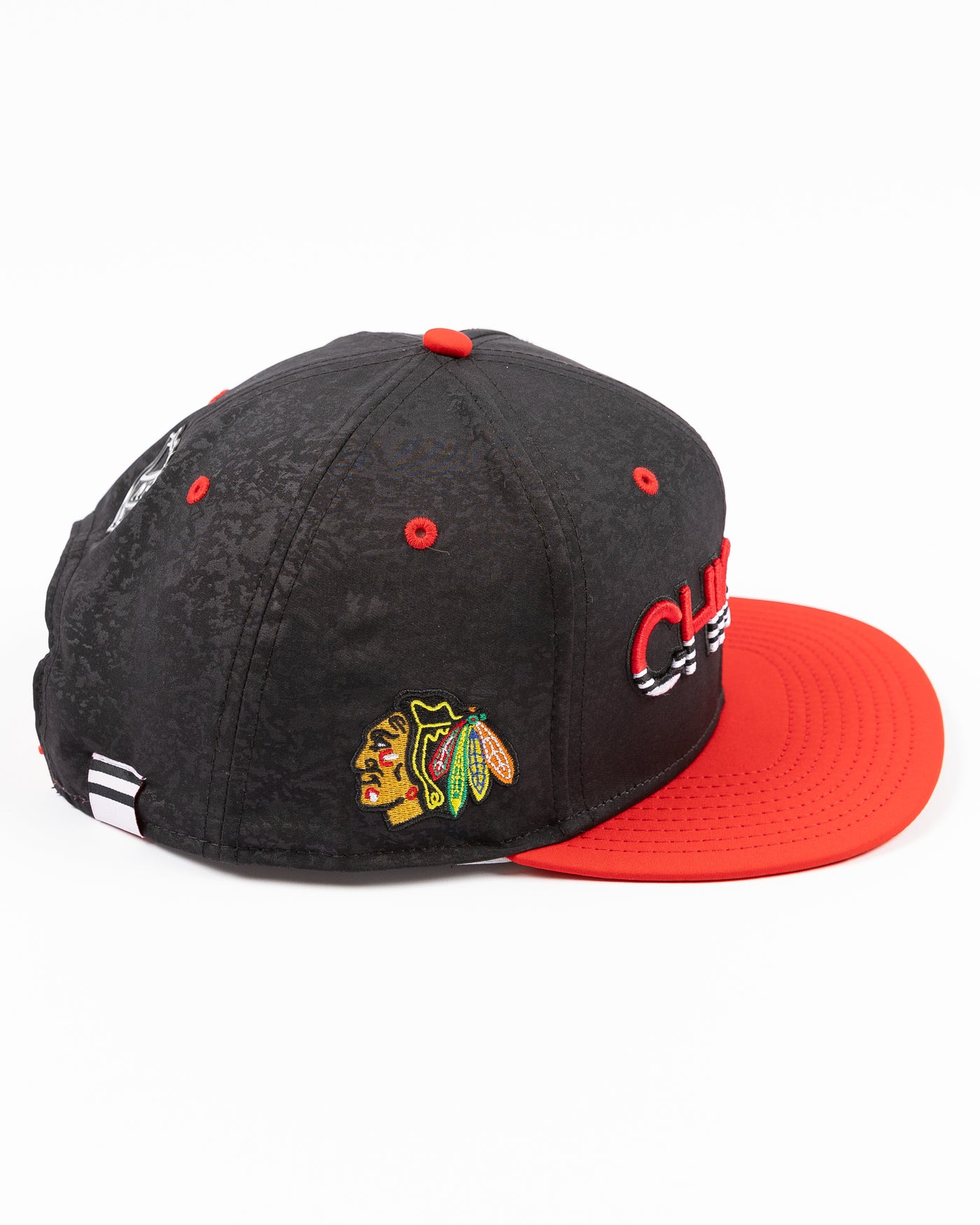 two tone black and red debossed Fanatics snapback cap with Chicago wordmark on front and Chicago Blackhawks primary logo embroidered on right side - right side lay flat