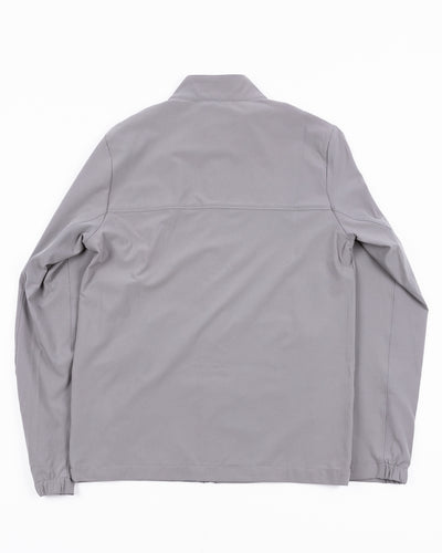 grey TravisMathew full zip jacket with Chicago Blackhawks primary logo embroidered on left shoulder - back lay flat