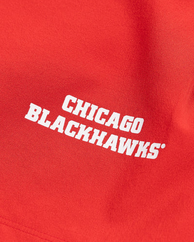 red lululemon men's shorts with Chicago Blackhawks wordmark printed on left leg - detail  lay flat