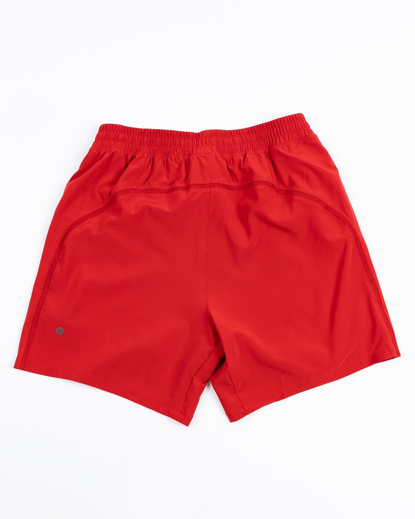 red lululemon men's shorts with Chicago Blackhawks wordmark printed on left leg - back lay flat