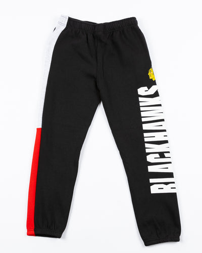 color blocked youth jogger with Chicago Blackhawks wordmark and primary logo on left leg - front lay flat