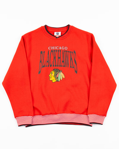 red youth crewneck sweater with Chicago Blackhawks wordmark and primary logo on front - front lay flat