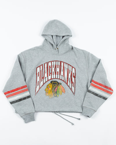 grey women's '47 brand cropped hoodie with Chicago Blackhawks wordmark and primary logo across front - front lay flat