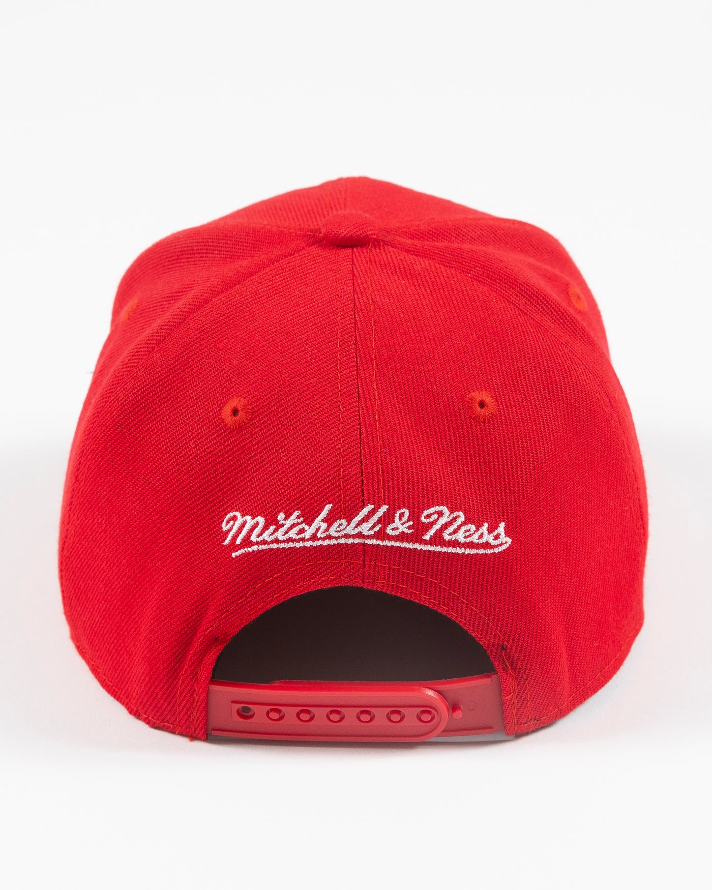 red Mitchell & Ness youth snapback with Chicago Blackhawks wordmark graphic and primary and secondary logos embroidered on front - back lay flat