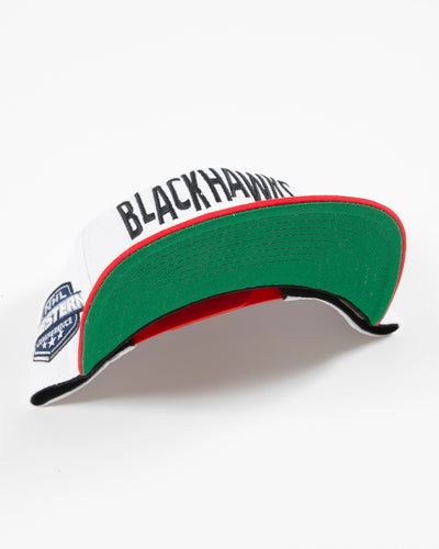 white and red Mitchell & Ness youth snapback with Chicago Blackhawks wordmark and primary logo embroidered on front - under brim lay flat
