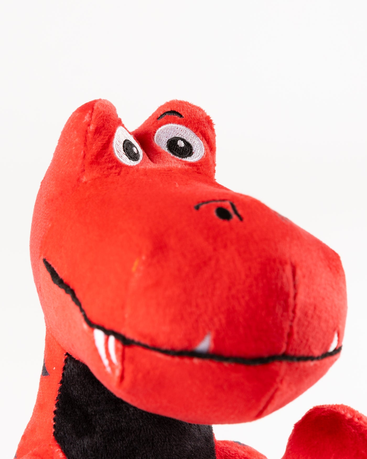 red dinosaur plush with Chicago Blackhawks primary logo on front - alt detail lay flat