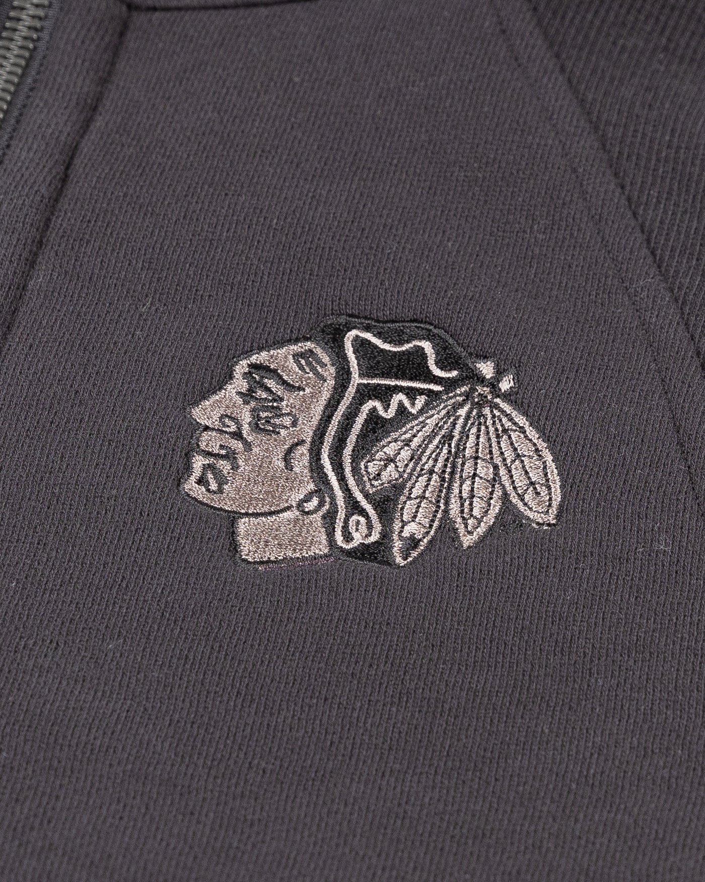 black lululemon cropped women's half zip with tonal Chicago Blackhawks primary logo embroidered on left chest - detail lay flat