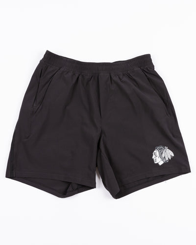 black lululemon men's shorts with tonal Chicago Blackhawks primary logo on left leg - front lay flat