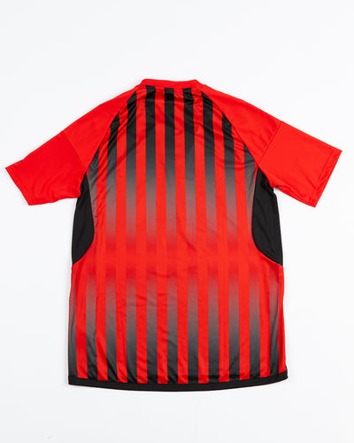 red adidas soccer inspired top with Chicago Blackhawks primary logo printed across the chest - back lay flat