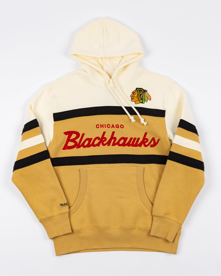cream and tan Mitchell & Ness hoodie with Chicago Blackhawks wordmark and primary logo on front - front lay flat