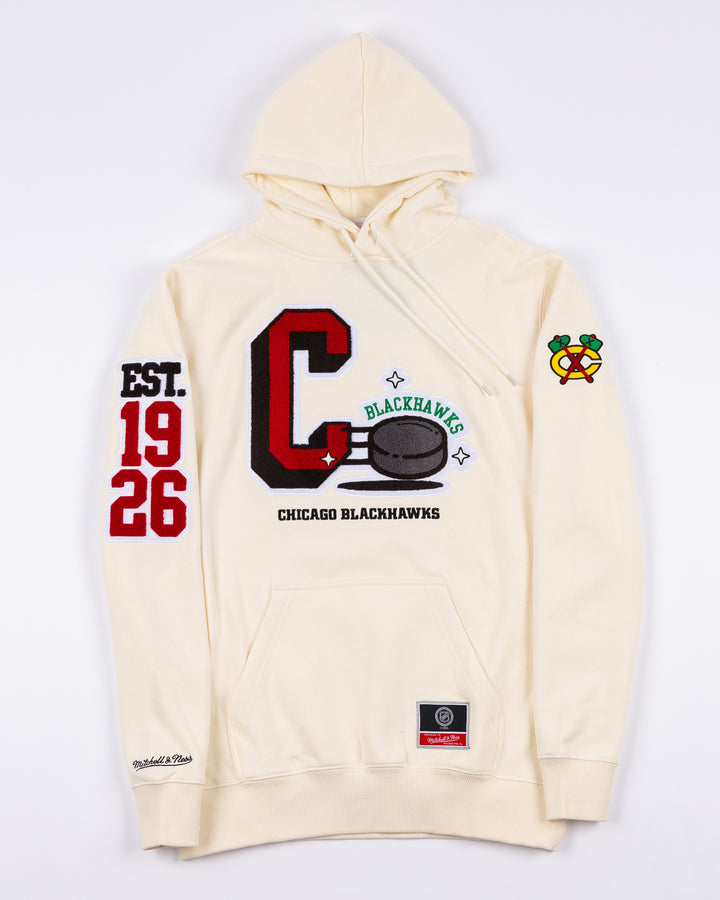 cream Mitchell & Ness hoodie with Chicago Blackhawks C and puck graphic embroidered on front with est. 1926 embroidered on right sleeve and secondary logo on left sleeve - front lay flat