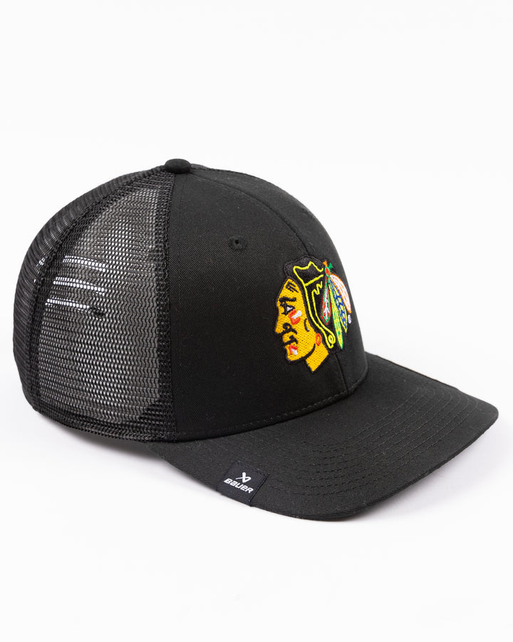 black Bauer adjustable mesh snapback trucker hat with Chicago Blackhawks primary logo embroidered on front - right angle lay flat