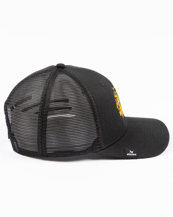 black Bauer adjustable mesh snapback trucker hat with Chicago Blackhawks primary logo embroidered on front - right side lay flat