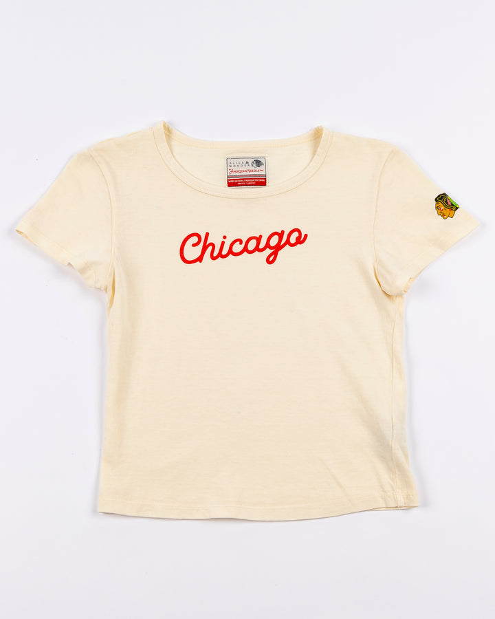 cream Alice & Wonder baby tee with red Chicago script graphic across front and Chicago Blackhawks logo on left sleeve - front lay flat