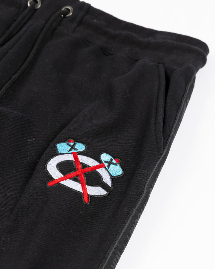 black sweatpants with Chicago Blackhawks secondary logo embroidered in Chicago flag colorway on left thigh and Chicago neighborhood names down sides - alt detail lay flat
