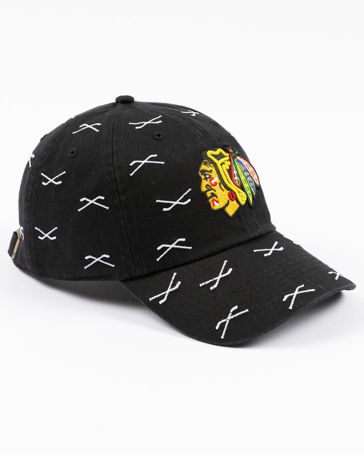 black '47 brand clean up adjustable cap with Chicago Blackhawks primary logo embroidered on front with all over hockey stick pattern - right angle lay flat