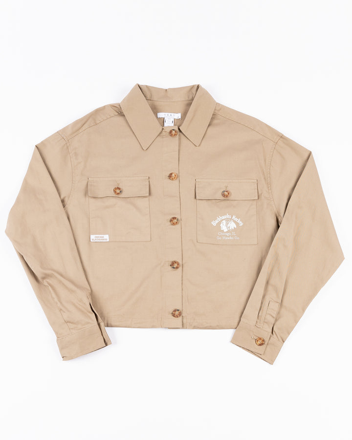 beige WEAR by Erin Andrews women's button down cropped shirt with Chicago Blackhawks wordmark and primary logo on left chest pocket - front lay flat