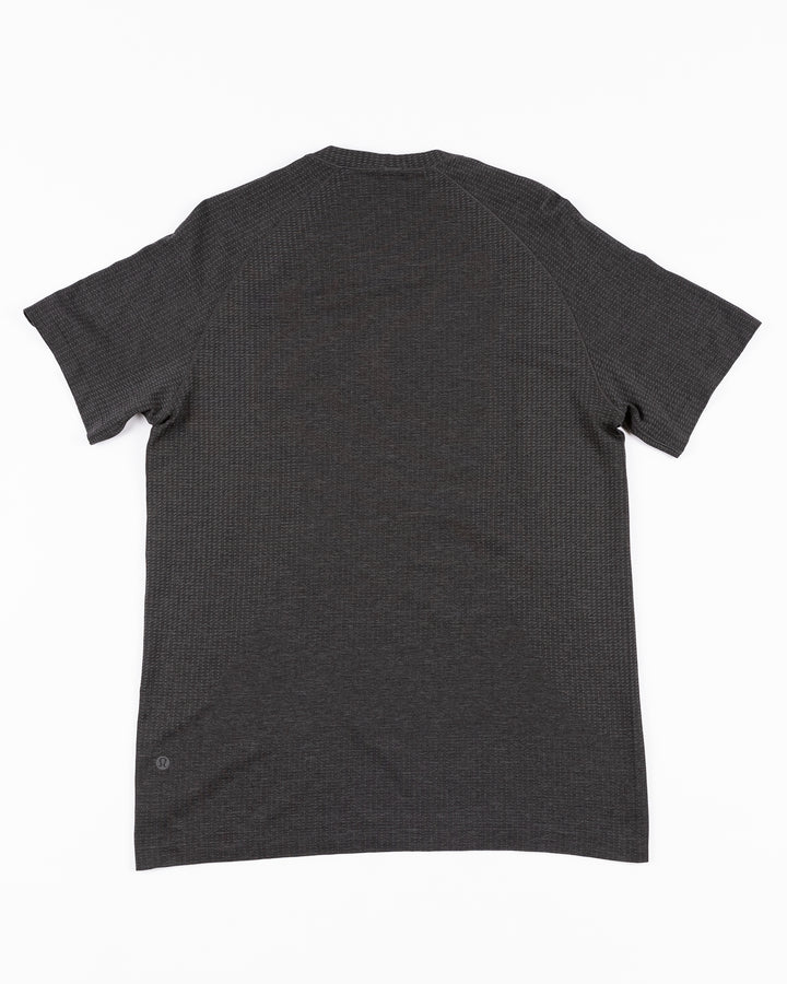 black lululemon short sleeve tee with Chicago Blackhawks wordmark across front - back lay flat