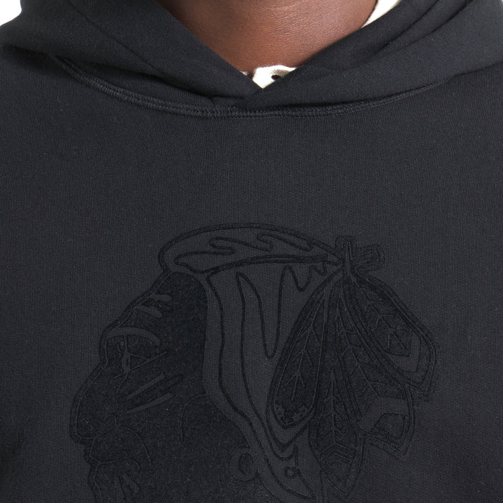 black Todd Snyder x Chicago Blackhawks in partnership with Fanatics hoodie with vintage logo on front and wordmark on left sleeve - on figure neckline detail image