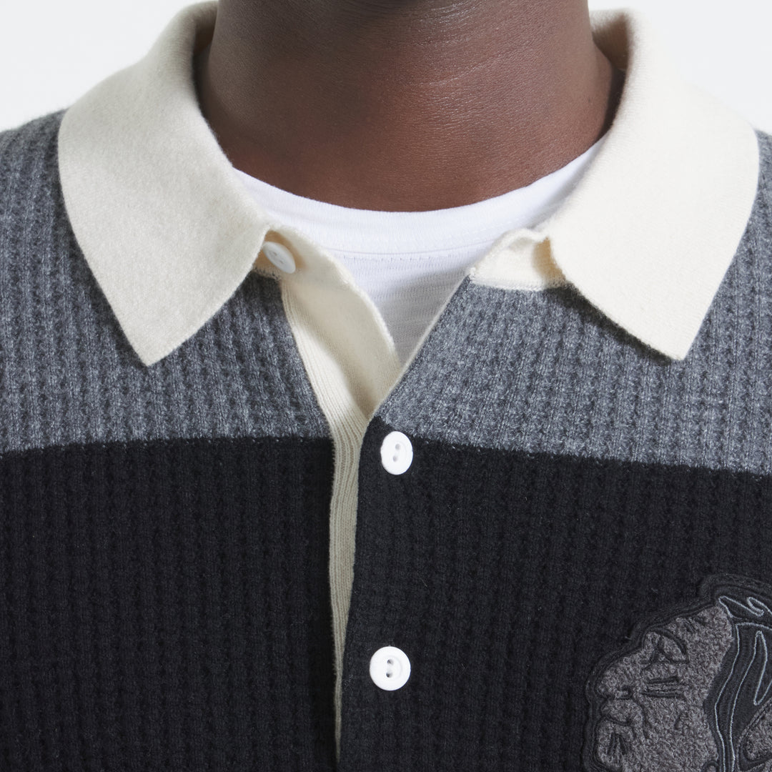 Todd Snyder x Chicago Blackhawks in partnership with Fanatics striped black and grey cashmere rugby polo sweater with vintage chenille Chicago Blackhawks logo on left chest - on figure neckline detail image