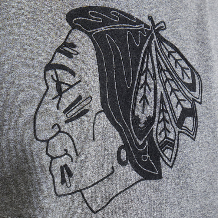 grey Todd Snyder x Chicago Blackhawks turtleneck sweater made with Fanatics with vintage logo on front and secondary logo on left shoulder - on figure logo detail image