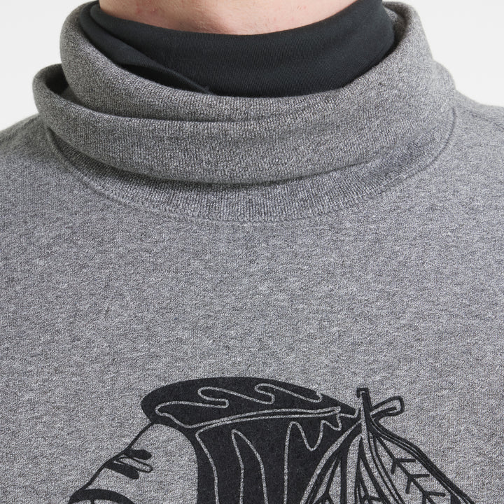 grey Todd Snyder x Chicago Blackhawks turtleneck sweater made with Fanatics with vintage logo on front and secondary logo on left shoulder - on figure turtleneck detail image