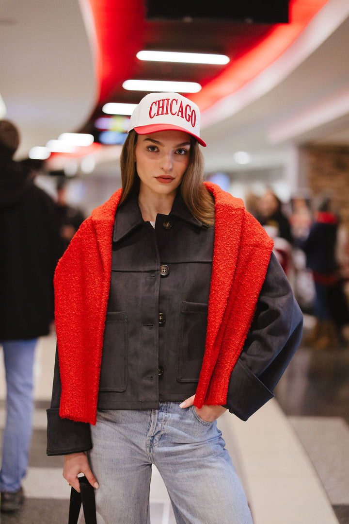 woman wearing cream and red Alice & Wonder hat with Chicago wordmark on front and Chicago Blackhawks primary logo on left side