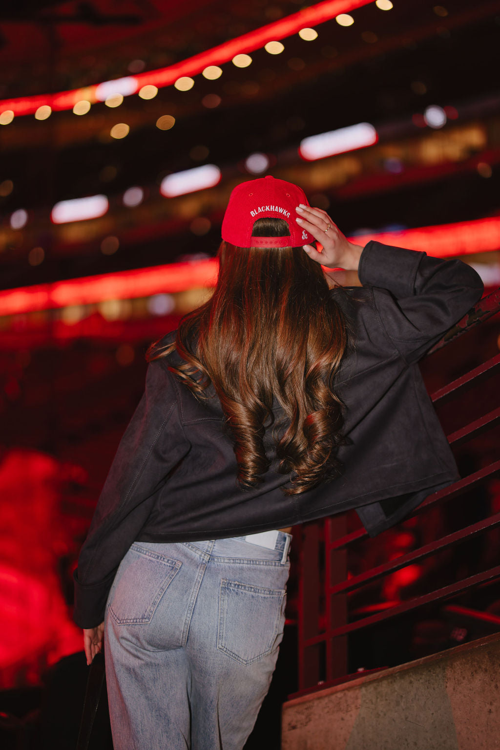 woman wearing red corduroy Alice & Wonder adjustable hat with white chainstitched Chicago script graphic on front and Chicago Blackhawks primary logo on left side 