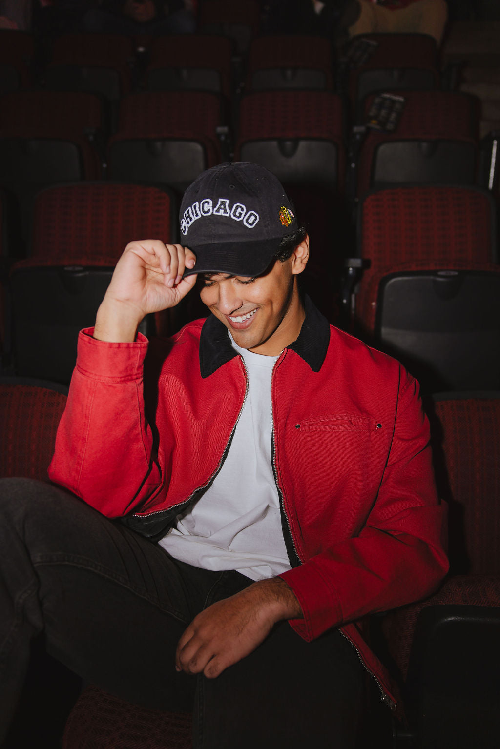 man wearing black Alice & Wonder adjustable hat with chainstiched Chicago graphic on front and Chicago Blackhawks primary logo on left side