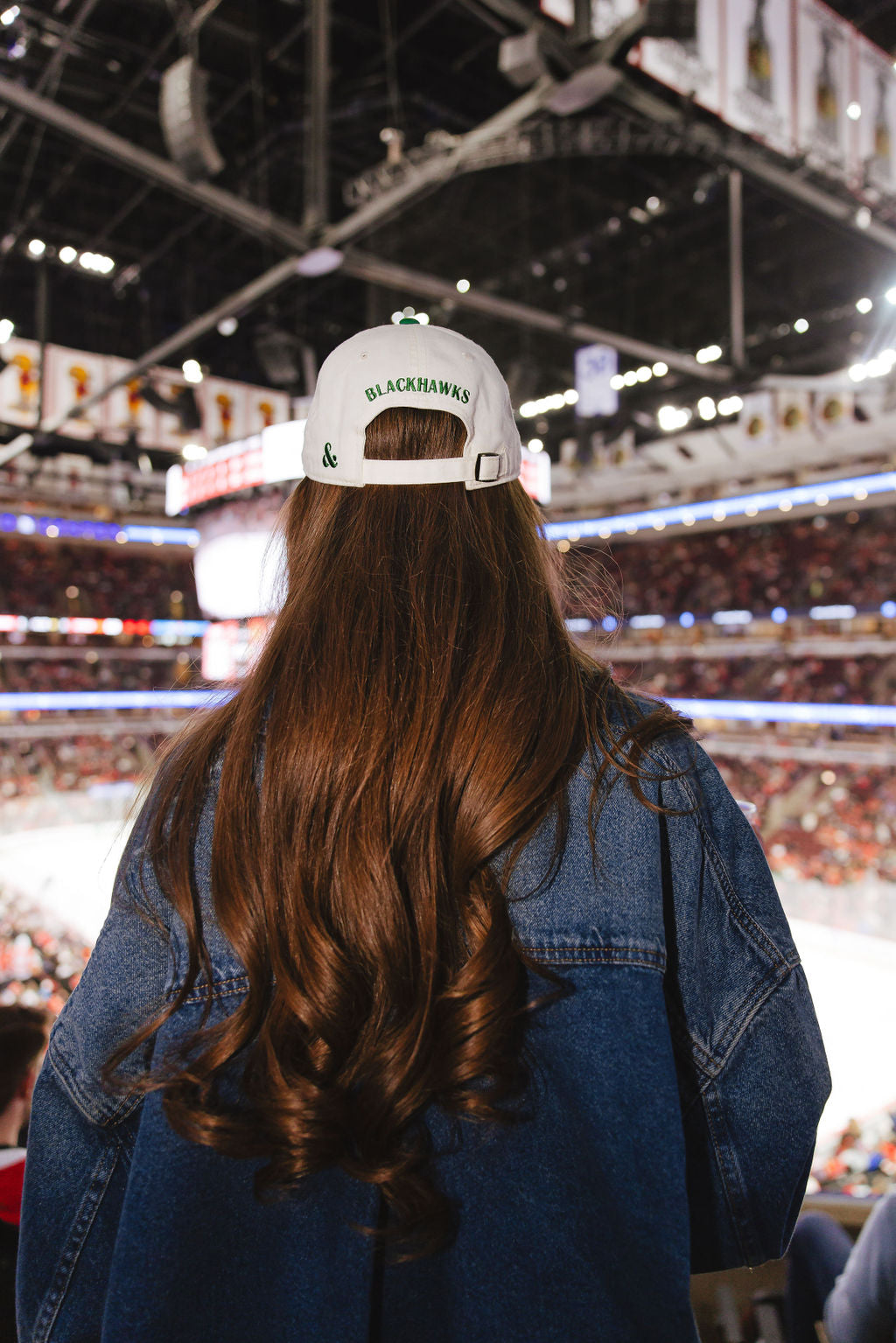 woman wearing cream and green Alice & Wonder hat with CHI chain stitched on front with Blackhawks wordmark on back