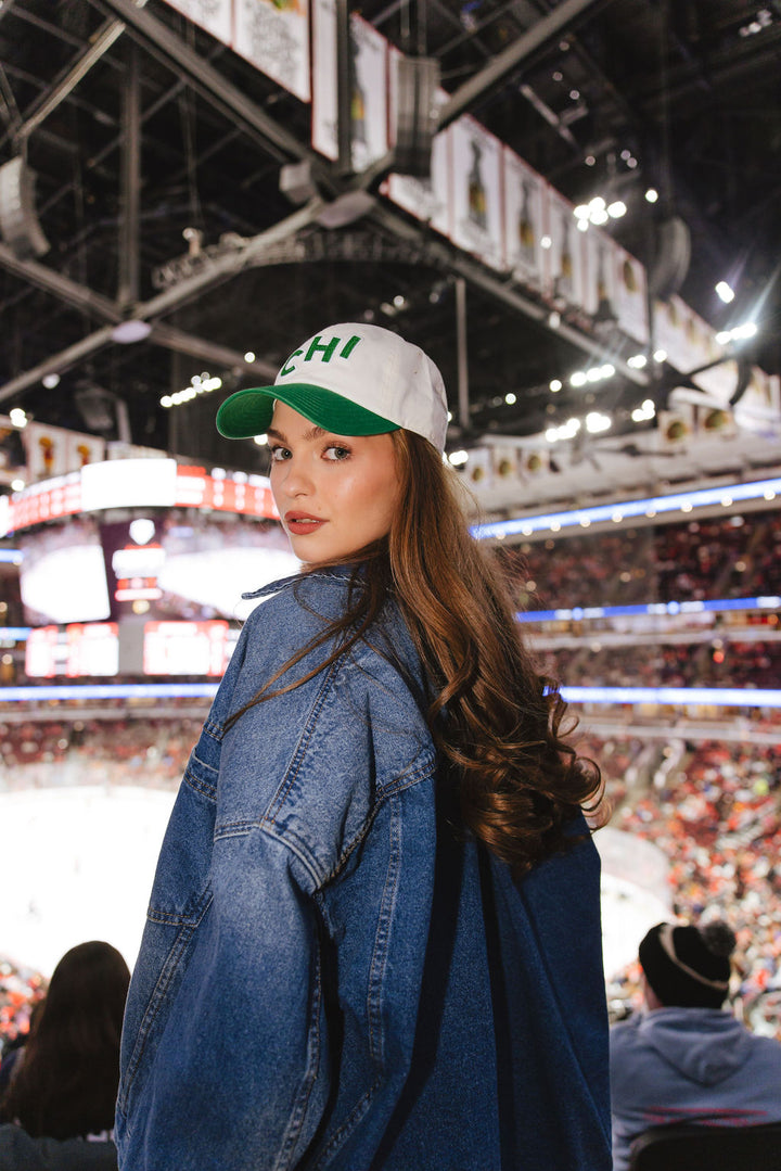 woman wearing cream and green Alice & Wonder hat with CHI chain stitched on front with Blackhawks wordmark on back