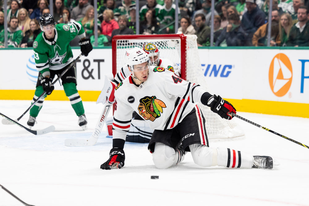 Chicago Blackhawks player Louis Crevier wearing white away jersey against Dallas Stars