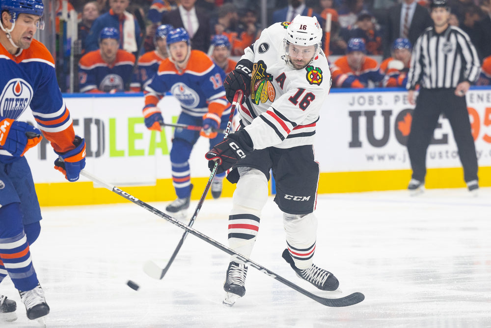 Chicago Blackhawks player Jason Dickinson wearing white adidas away jersey against Edmonton Oilers 