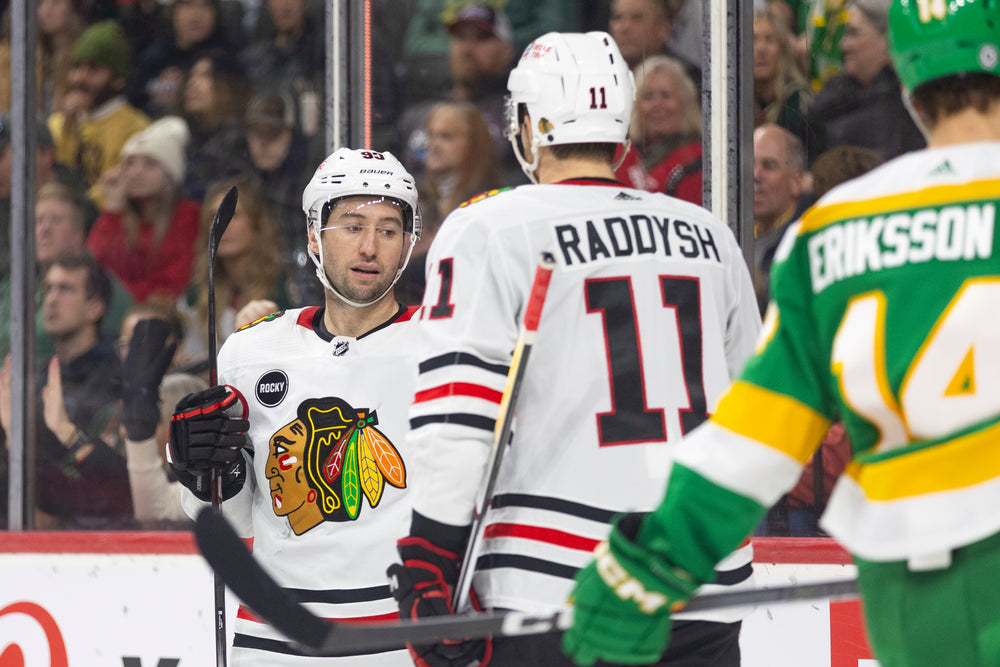 Chicago Blackhawks players Tyler Johnson and Taylor Raddysh at away game