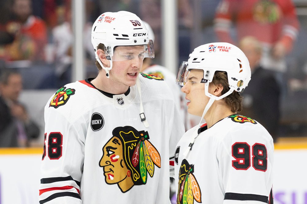 Chicago Blackhawks players Mackezie Entwistle and Connor Bedard at away game