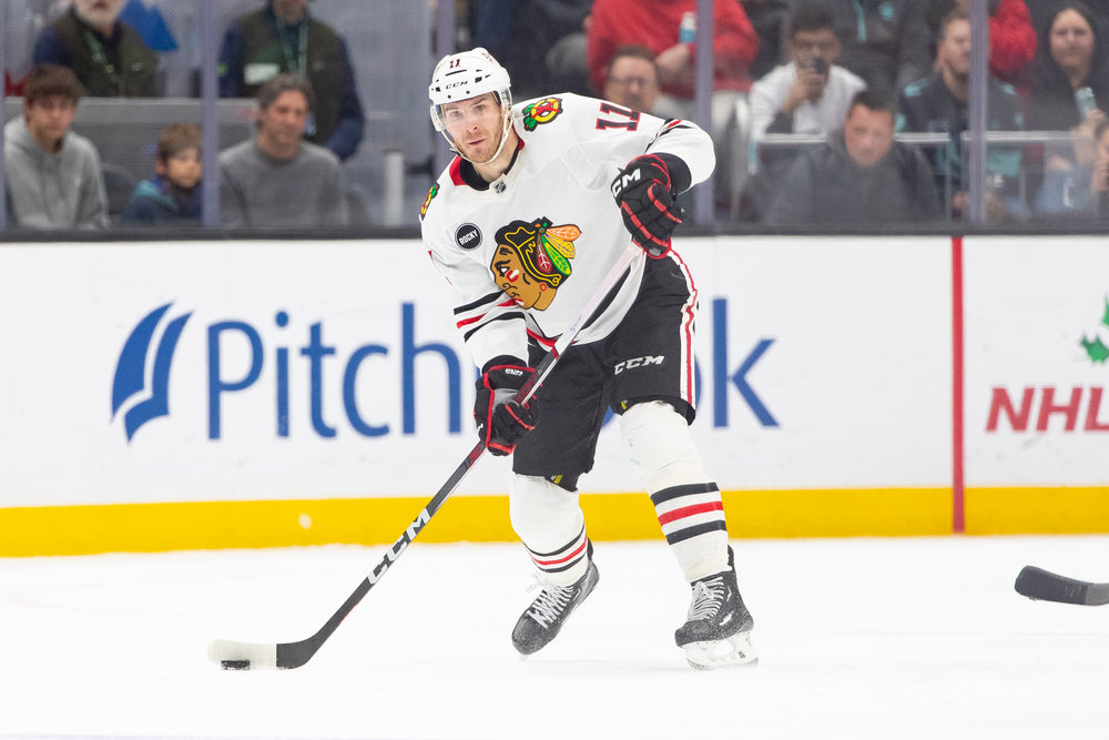 Taylor Raddysh in white Chicago Blackhawks away uniform at Seattle Kraken