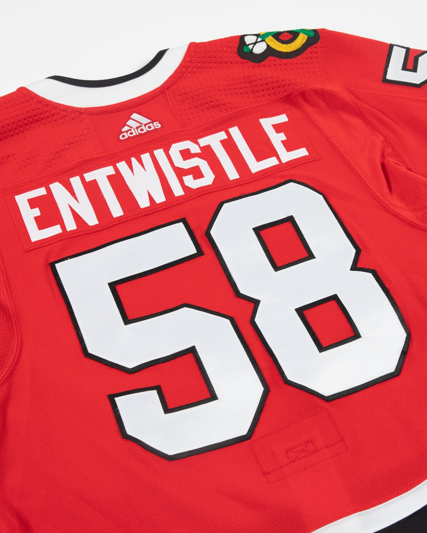 Autographed Chicago Blackhawks Mackenzie Entwistle team issued red jersey - close up back angle