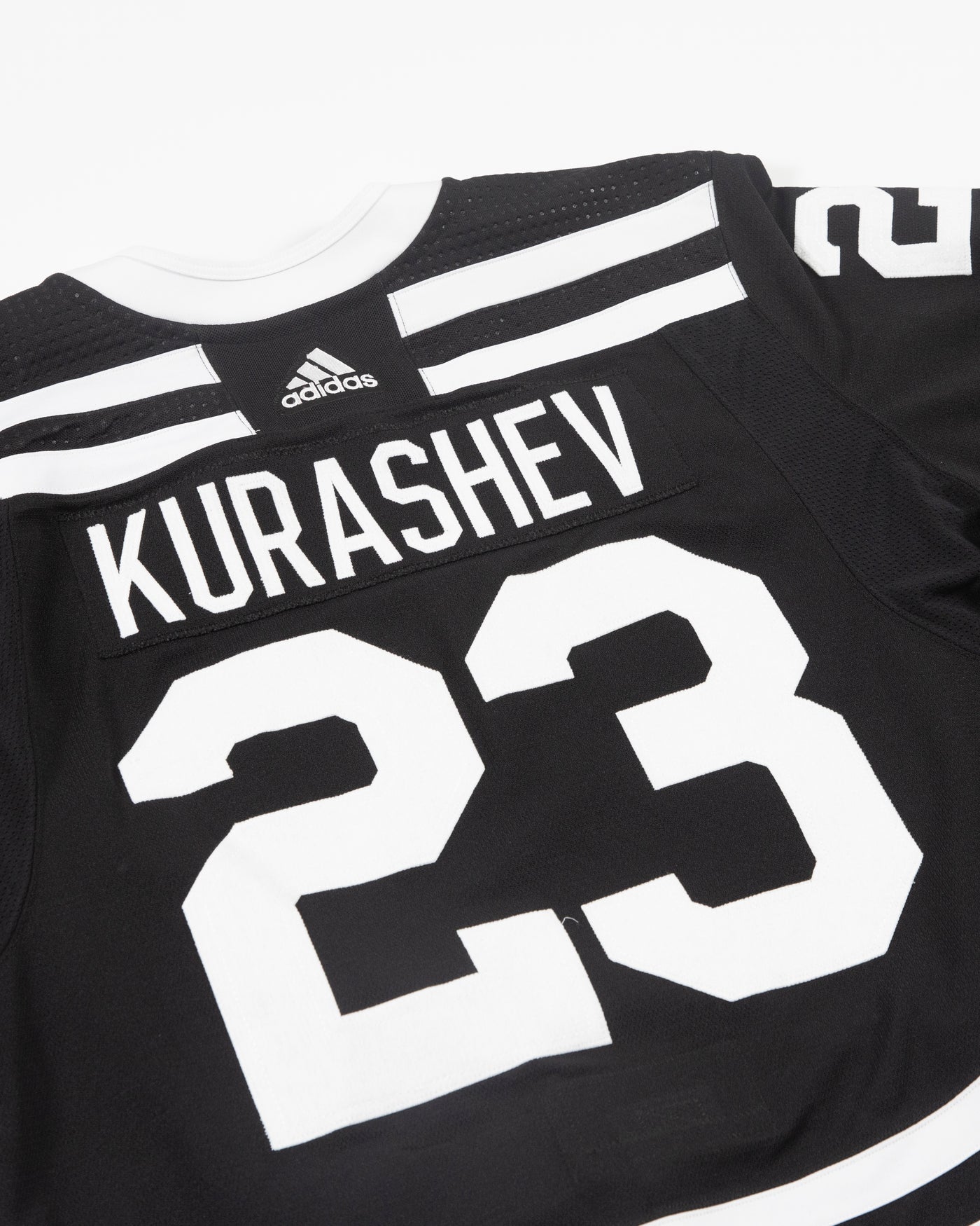 Autographed Chicago Blackhawks Philip Kurashev team issued alternate jersey - alt back view