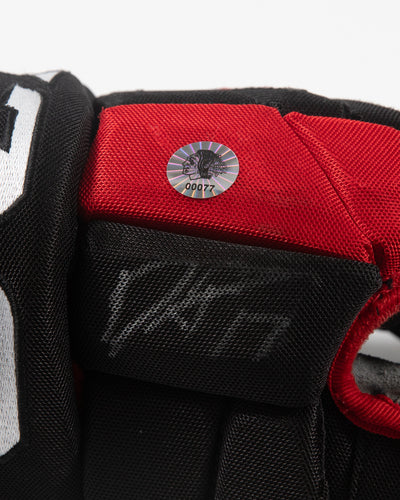 Autographed Chicago Blackhawks CCM Dylan Strome game used hockey gloves - close up of autograph ad hologram sticker