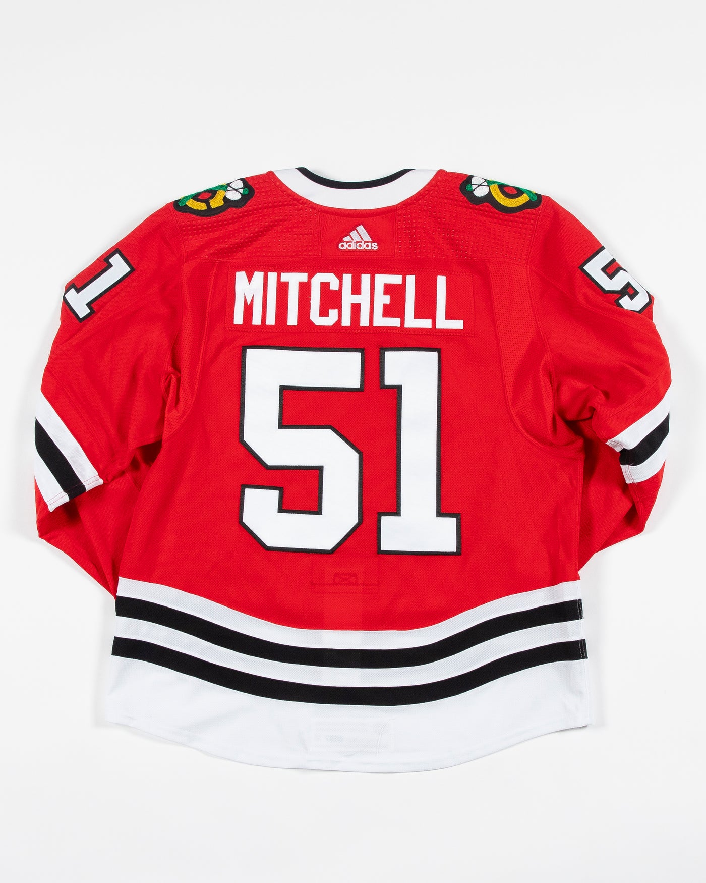 Autographed Chicago Blackhawks Ian Mitchell team issued red jersey - back angle