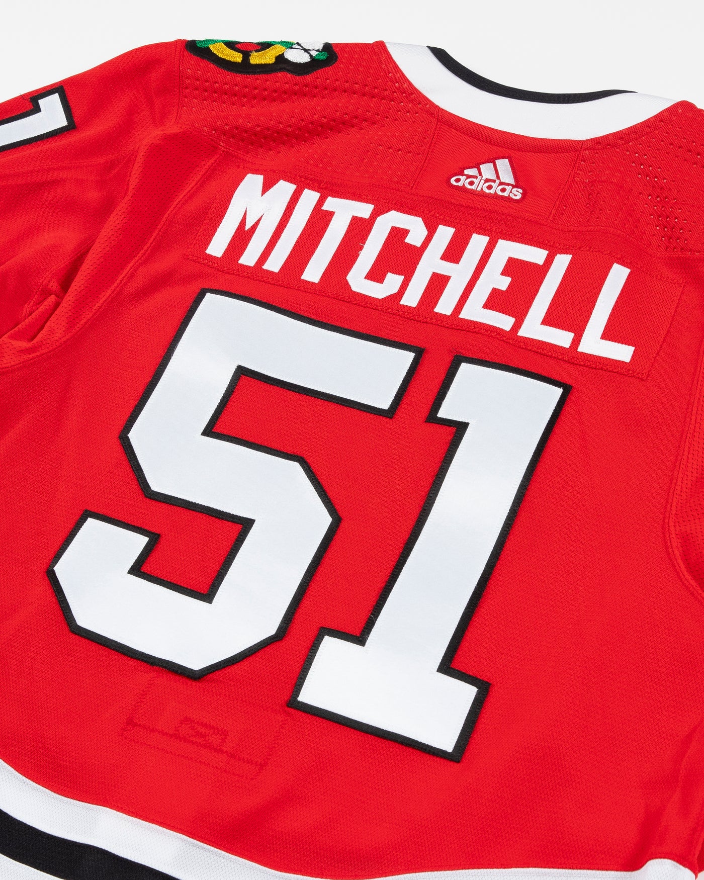 Autographed Chicago Blackhawks Ian Mitchell team issued red jersey - back close up