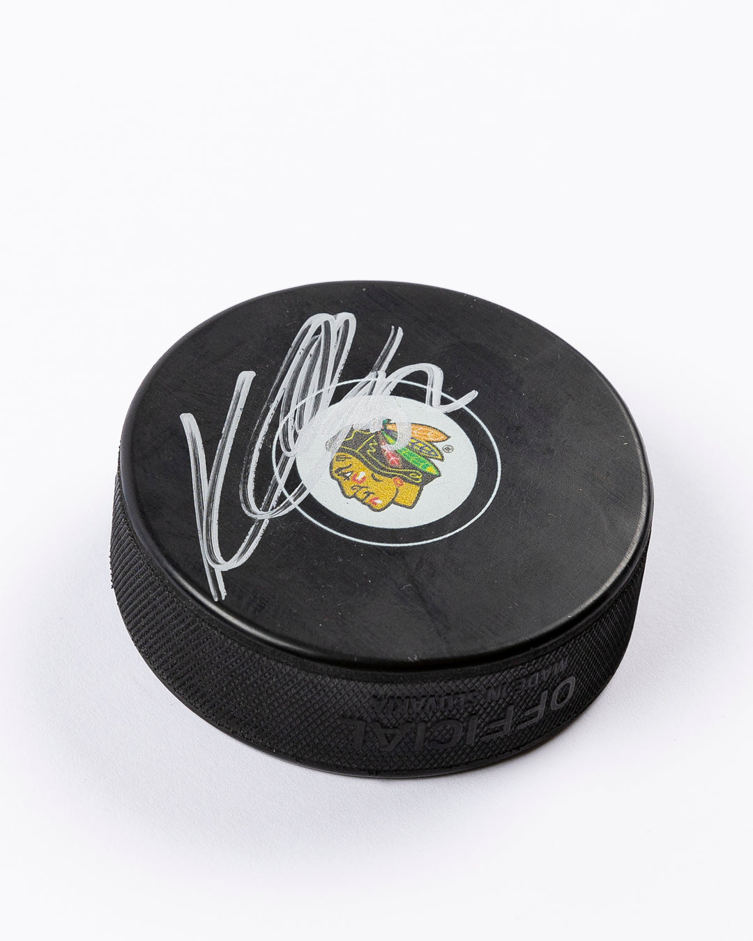 signed Chicago Blackhawks hockey puck signed by Kevin Lankinen - front detail lay flat