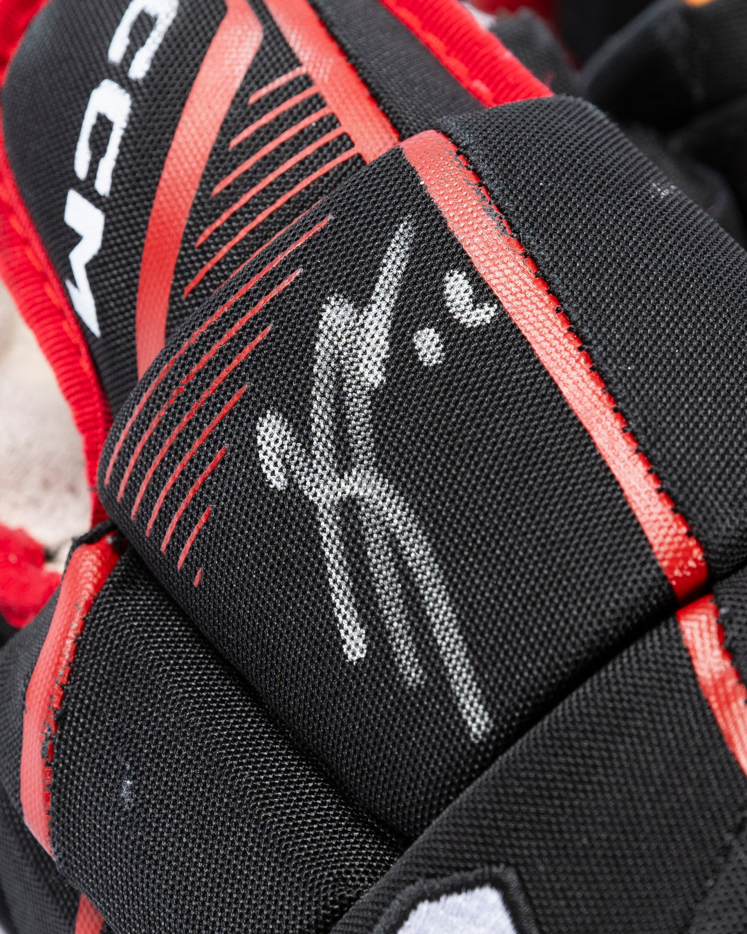 CCM game-used hockey gloves signed by Chicago Blackhawks Jason Dickinson - autograph detail lay flat