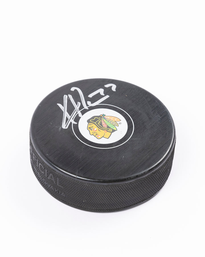 Chicago Blackhawks Kirby Dach signed puck from 2021-22 season - autograph detail lay flat